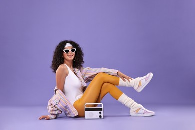 Photo of Aerobics. Woman with radio receiver on purple background