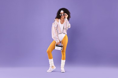 Photo of Aerobics. Woman with radio receiver on purple background