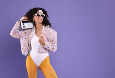 Photo of Aerobics. Woman with radio receiver on purple background, space for text