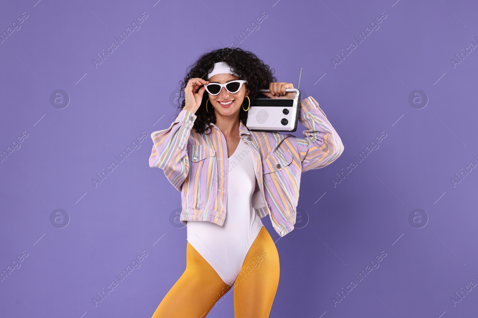 Photo of Aerobics. Woman with radio receiver on purple background