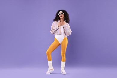 Photo of Aerobics. Happy woman in sunglasses on purple background, space for text