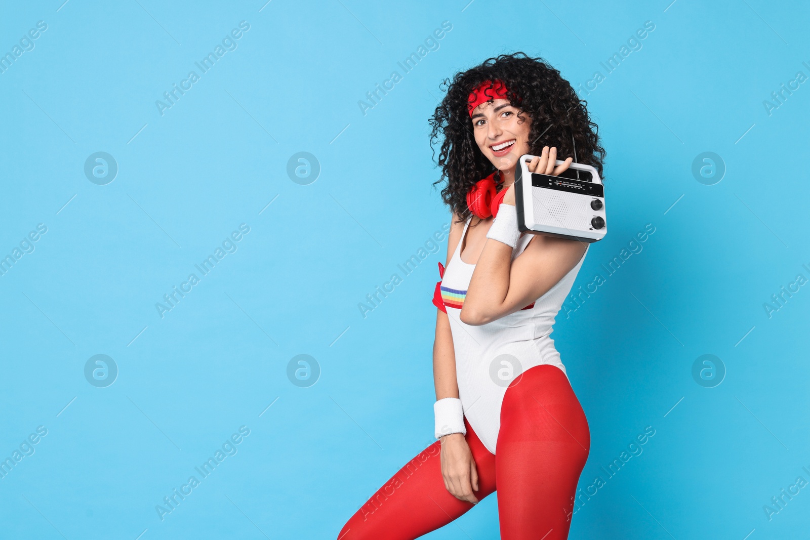 Photo of Aerobics. Happy woman with radio receiver on light blue background, space for text