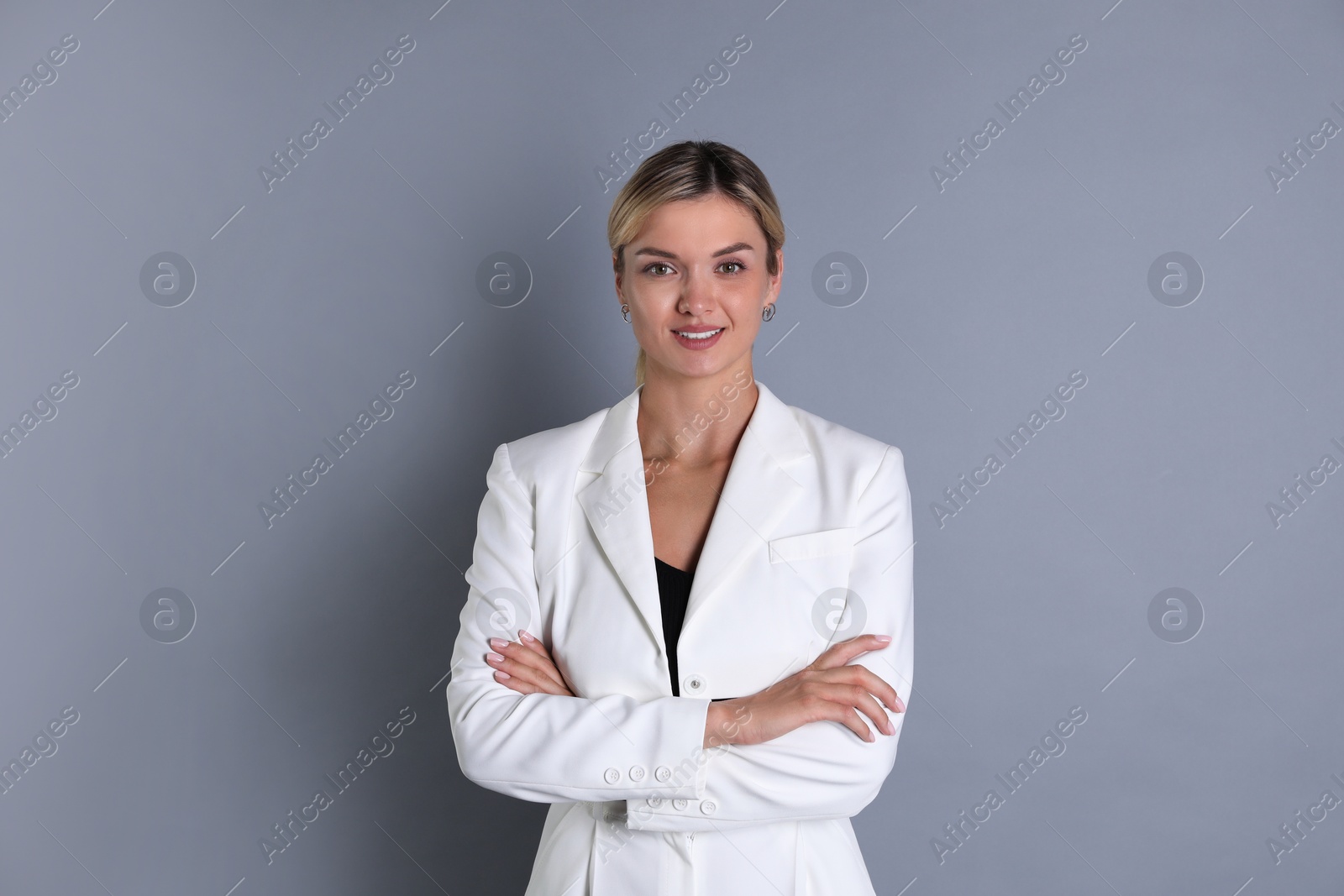 Photo of Beautiful woman in stylish white suit on grey background