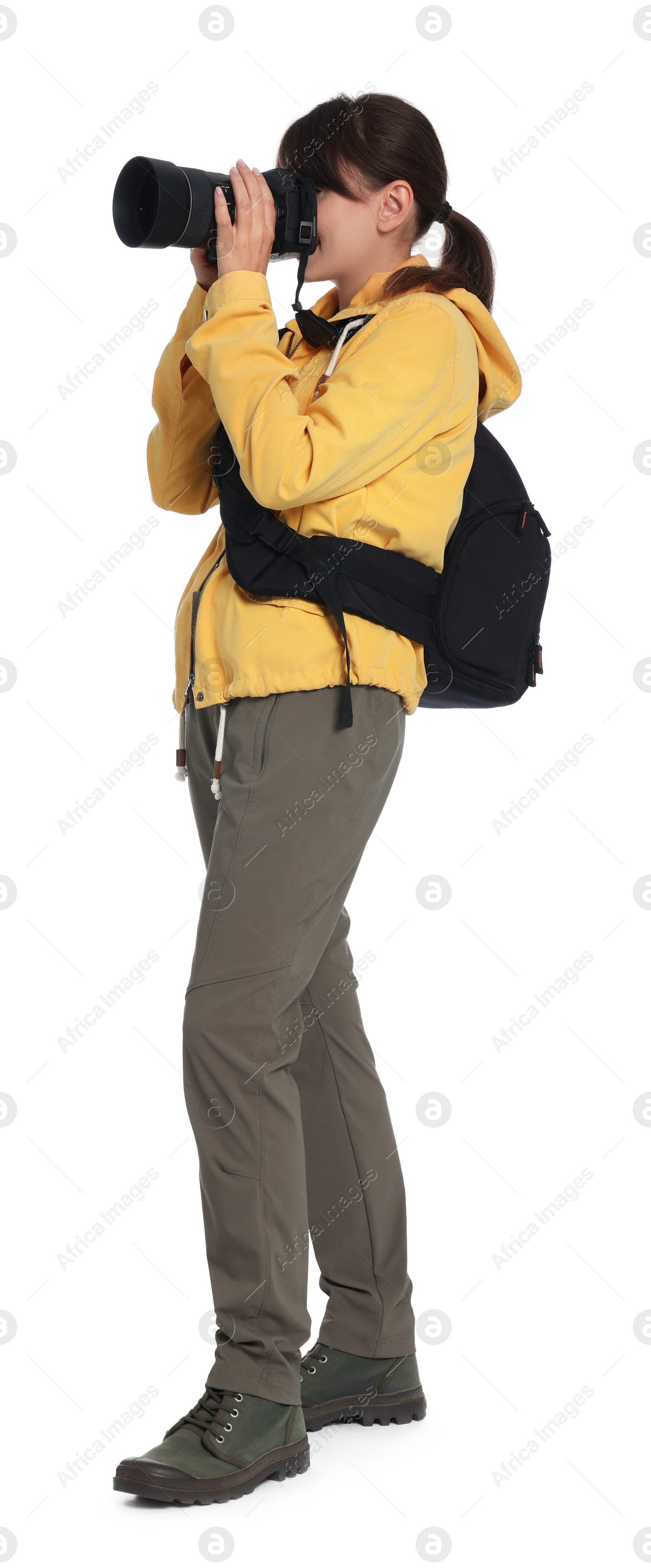 Photo of Photographer with backpack and camera taking picture on white background