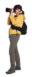 Photo of Photographer with backpack and camera taking picture on white background