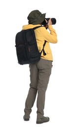 Photo of Photographer with backpack and camera taking picture on white background