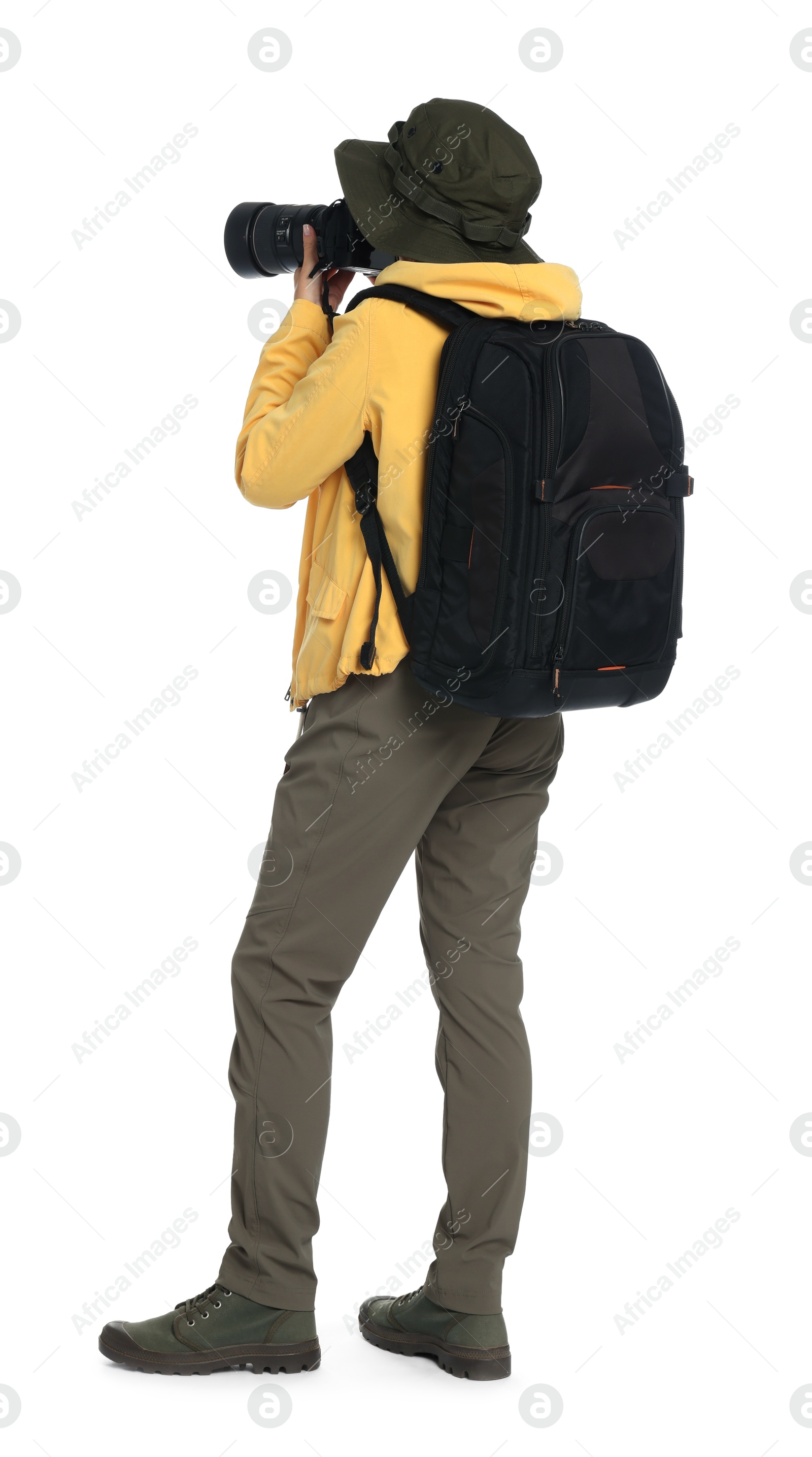 Photo of Photographer with backpack and camera taking picture on white background