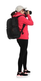 Photo of Photographer with backpack and camera taking picture on white background