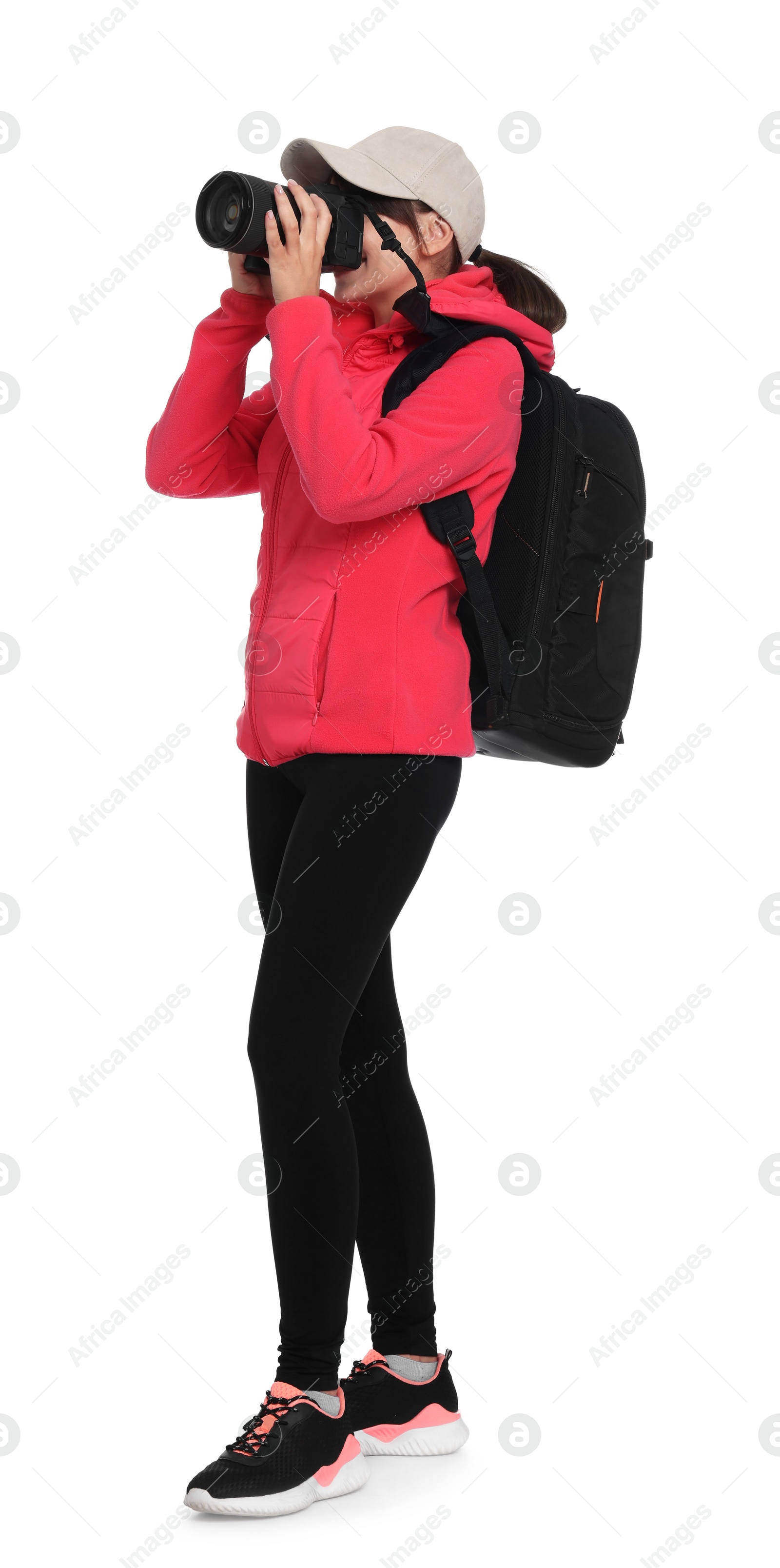 Photo of Photographer with backpack and camera taking picture on white background