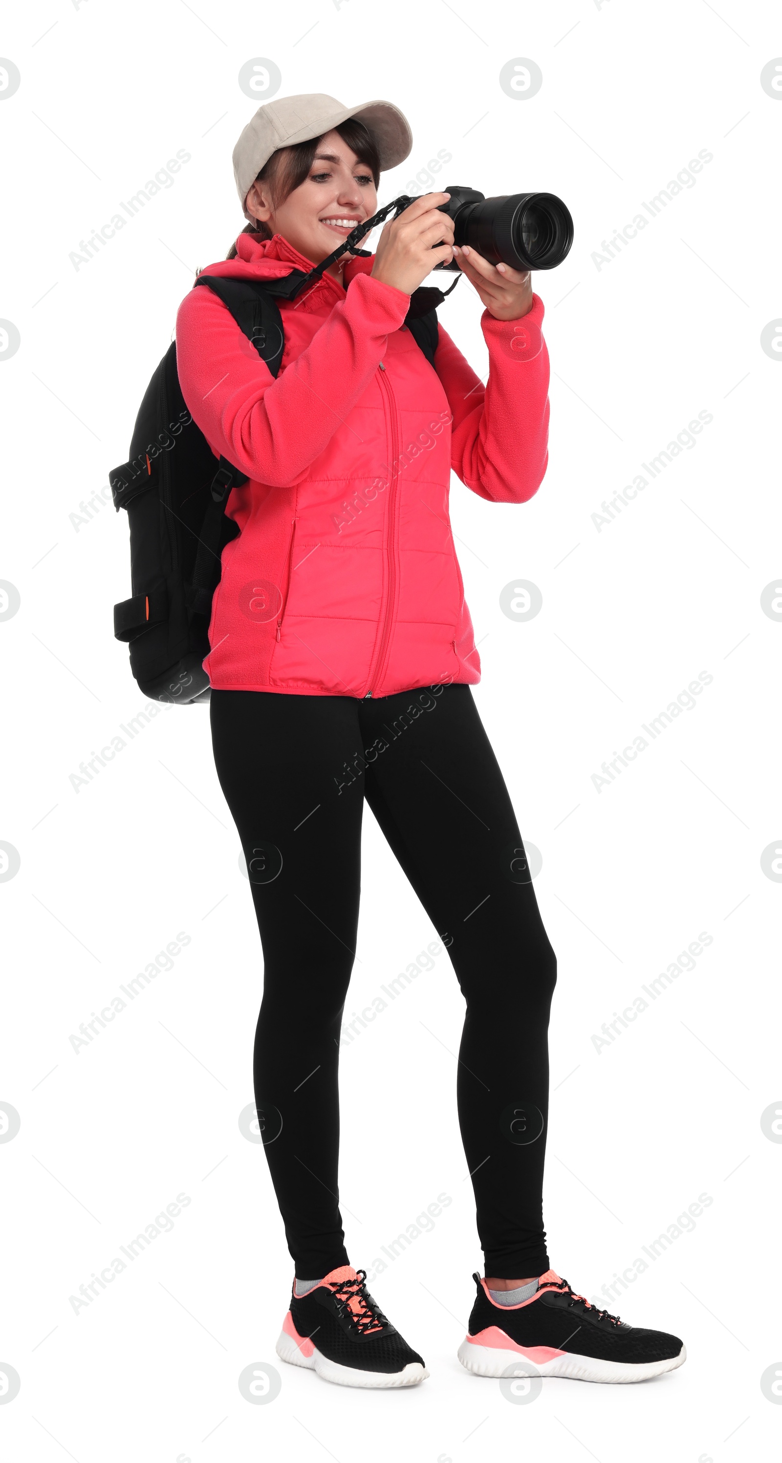 Photo of Photographer with backpack and camera taking picture on white background