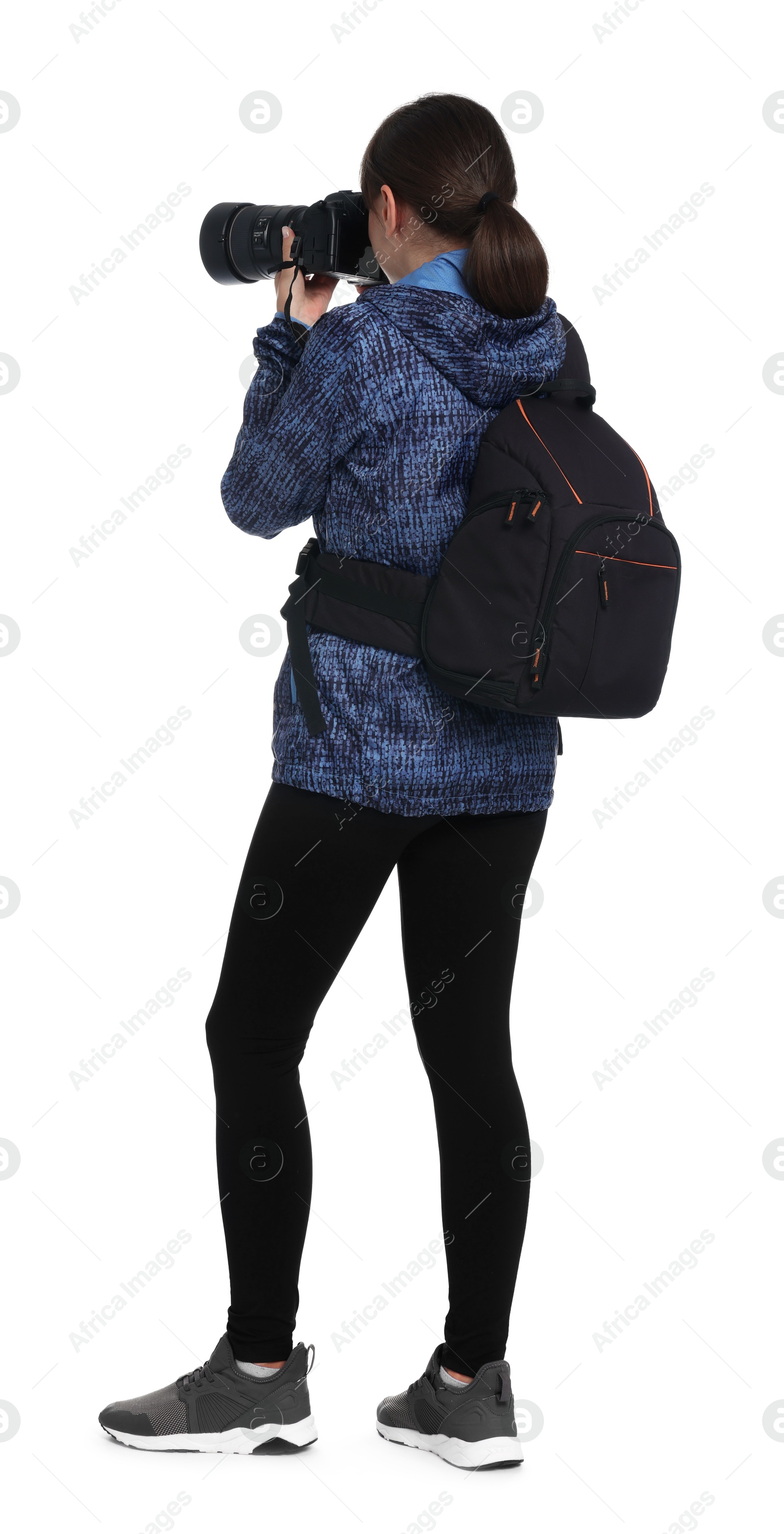 Photo of Photographer with backpack and camera taking picture on white background, back view