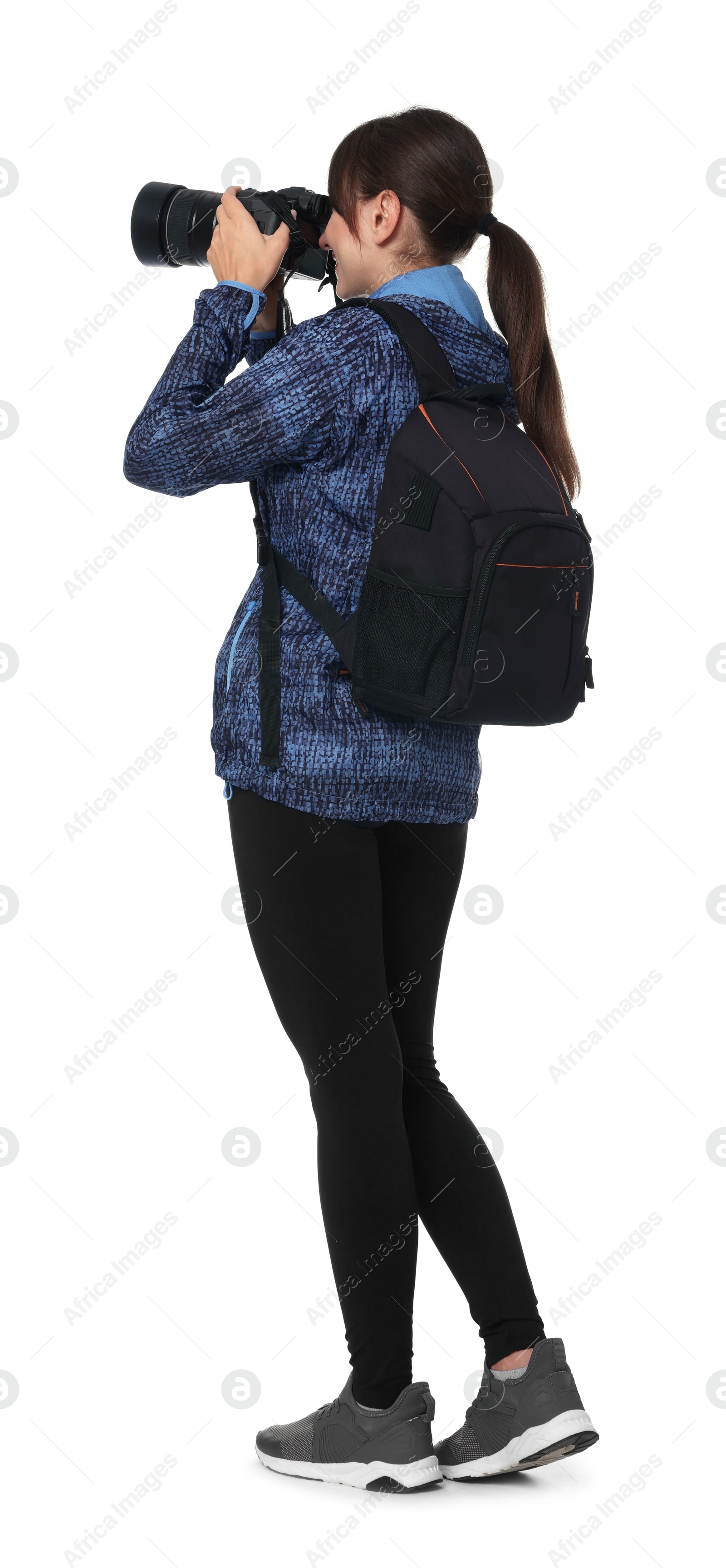 Photo of Photographer with backpack and camera taking picture on white background