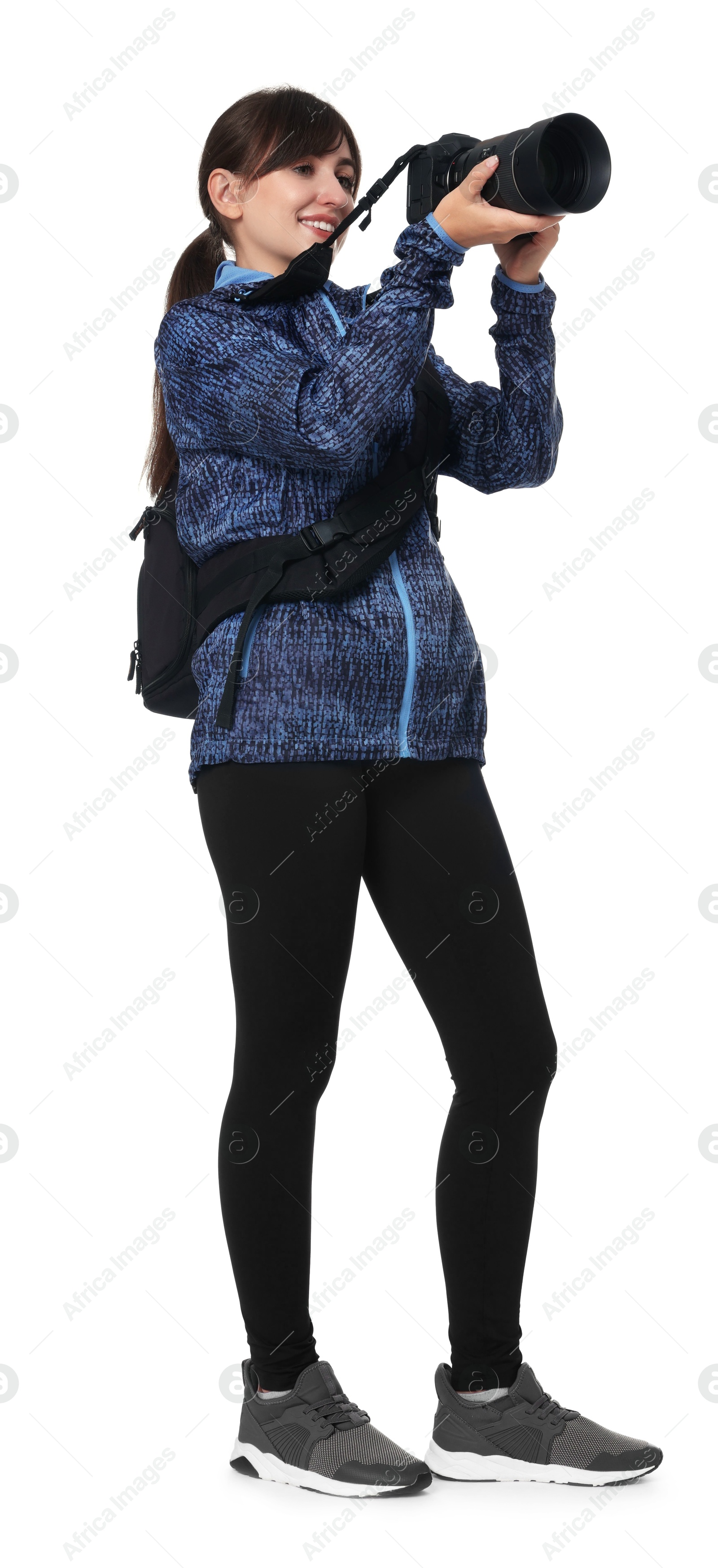 Photo of Photographer with backpack and camera taking picture on white background