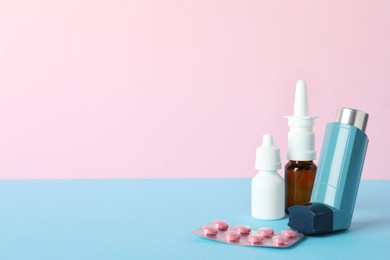 Photo of Different asthma medications on color background, closeup. Space for text