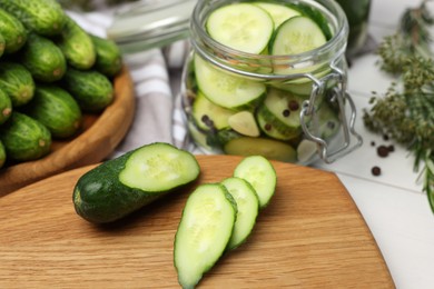 Photo of Fresh cucumbers on light table, closeup. Preparation for pickling