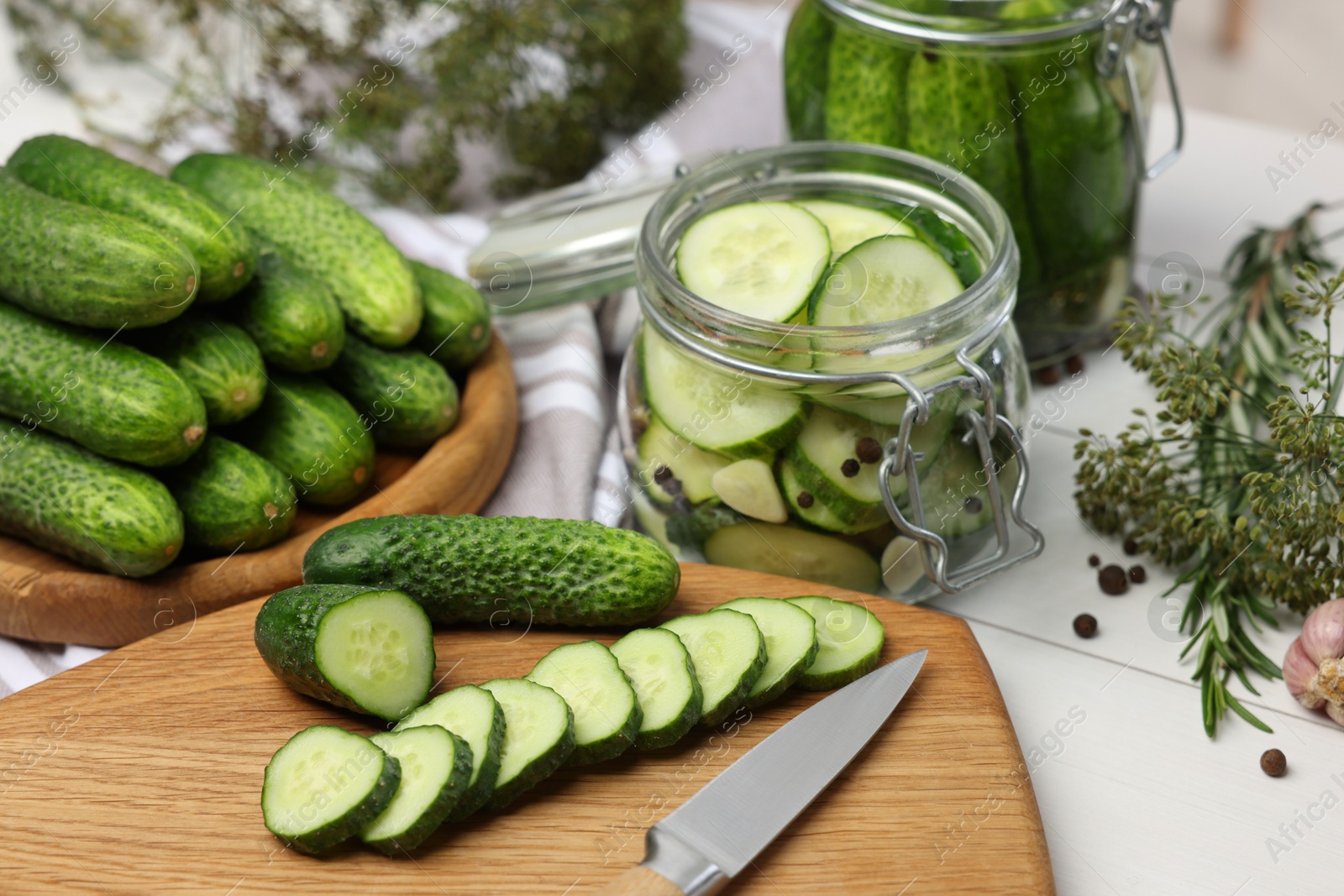 Photo of Fresh cucumbers on light table, closeup. Preparation for pickling