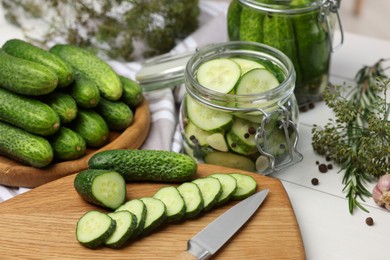 Photo of Fresh cucumbers on light table, closeup. Preparation for pickling