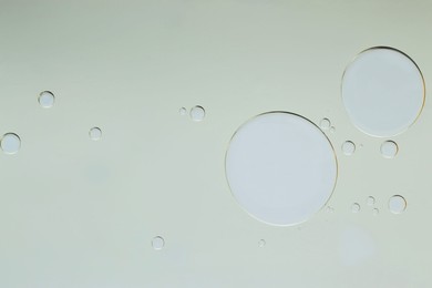 Photo of Sample of cosmetic oil on light grey background, macro view