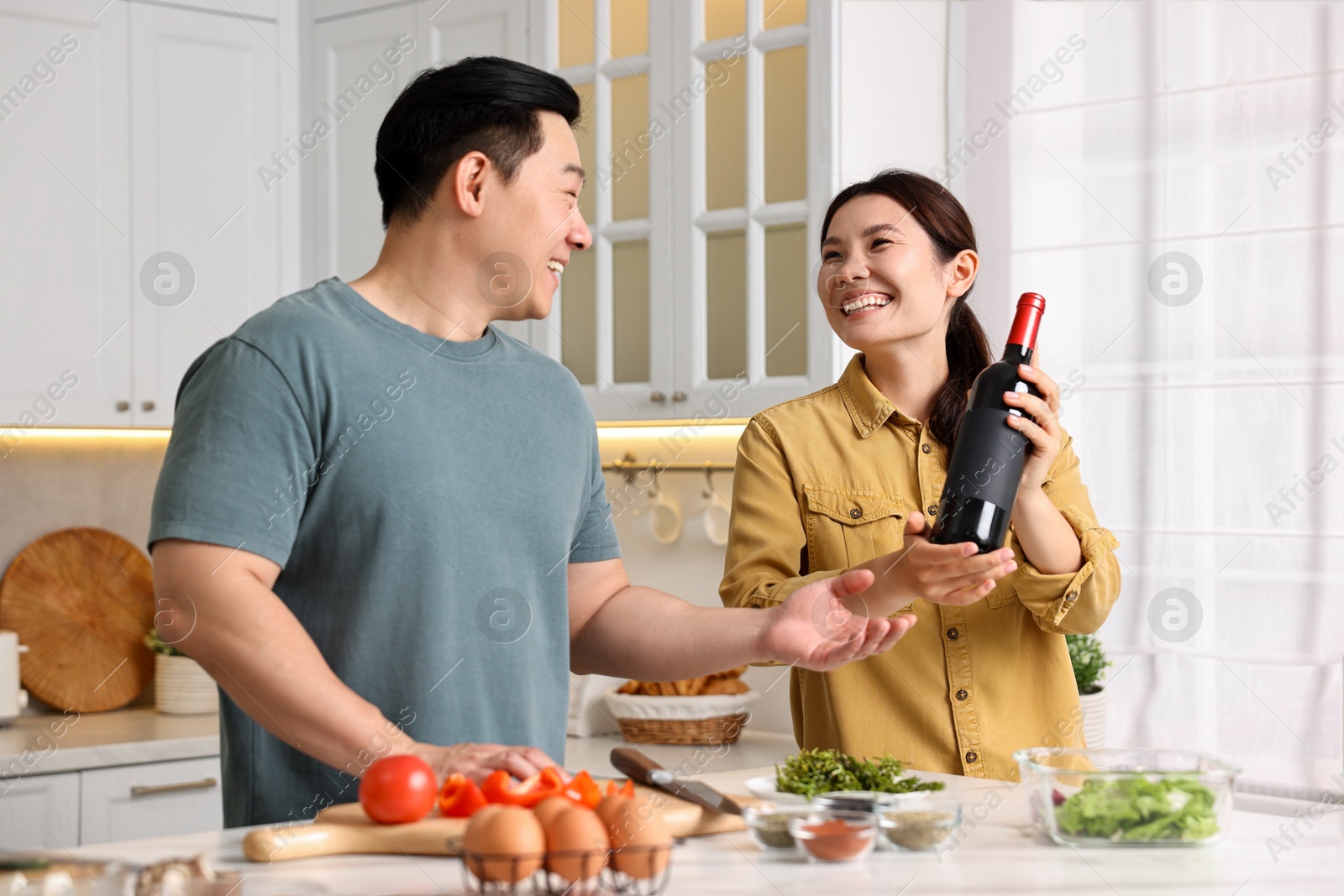 Photo of Happy lovely couple cooking together in kitchen