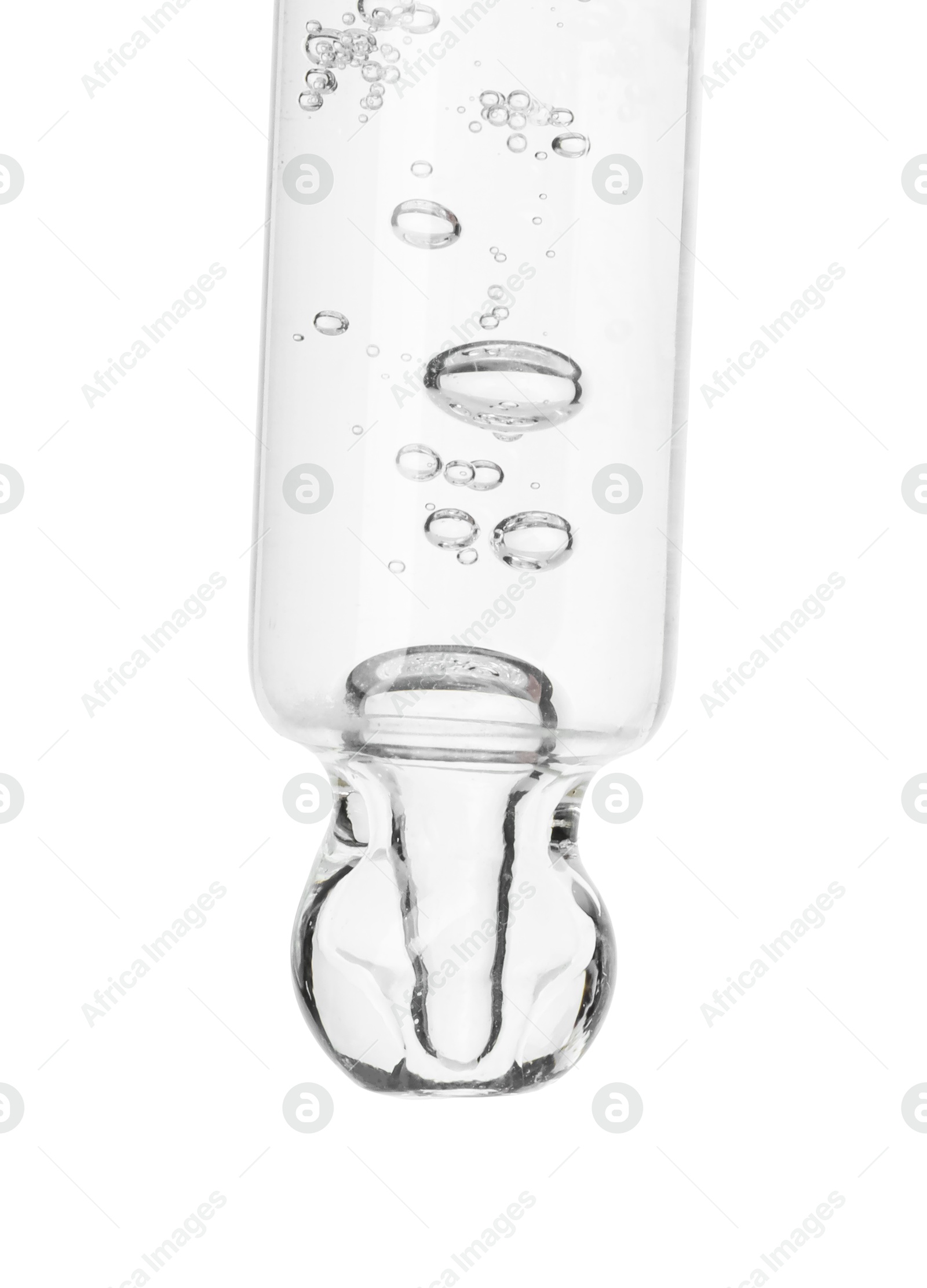 Photo of Dripping cosmetic serum from pipette on white background