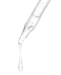 Photo of Dripping cosmetic serum from pipette on white background