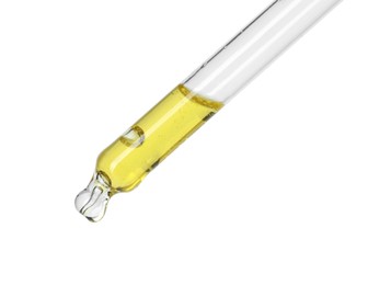 Dripping essential oil from pipette on white background