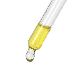 Dripping essential oil from pipette on white background