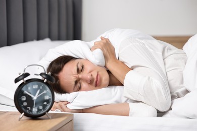 Sleepy woman in bed at lunch time