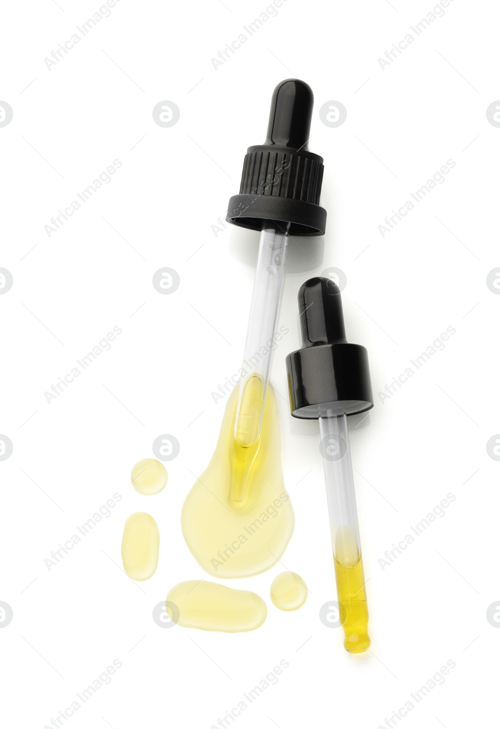 Photo of Cosmetic oil and pipettes isolated on white, top view