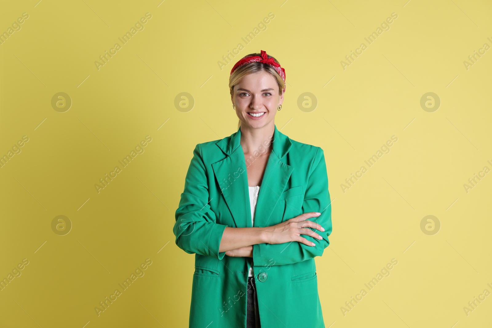 Photo of Beautiful woman in stylish green jacket on yellow background