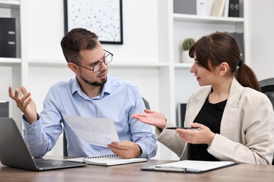 Consultant working with client at table in office. Business meeting