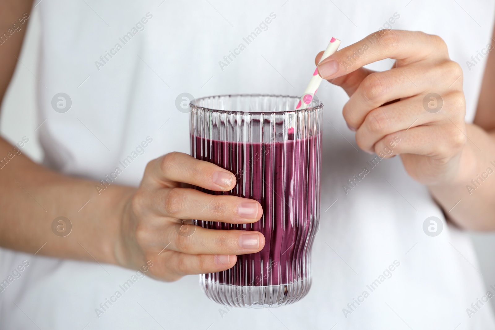 Photo of Woman with glass of tasty fresh acai juice, closeup