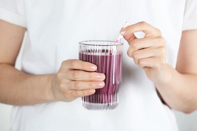 Woman with glass of tasty fresh acai juice, closeup