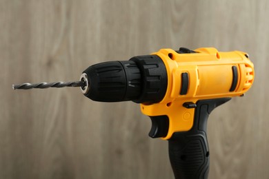 One cordless electric drill against blurred background