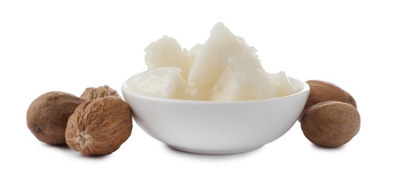 Natural shea butter in bowl and nuts isolated on white