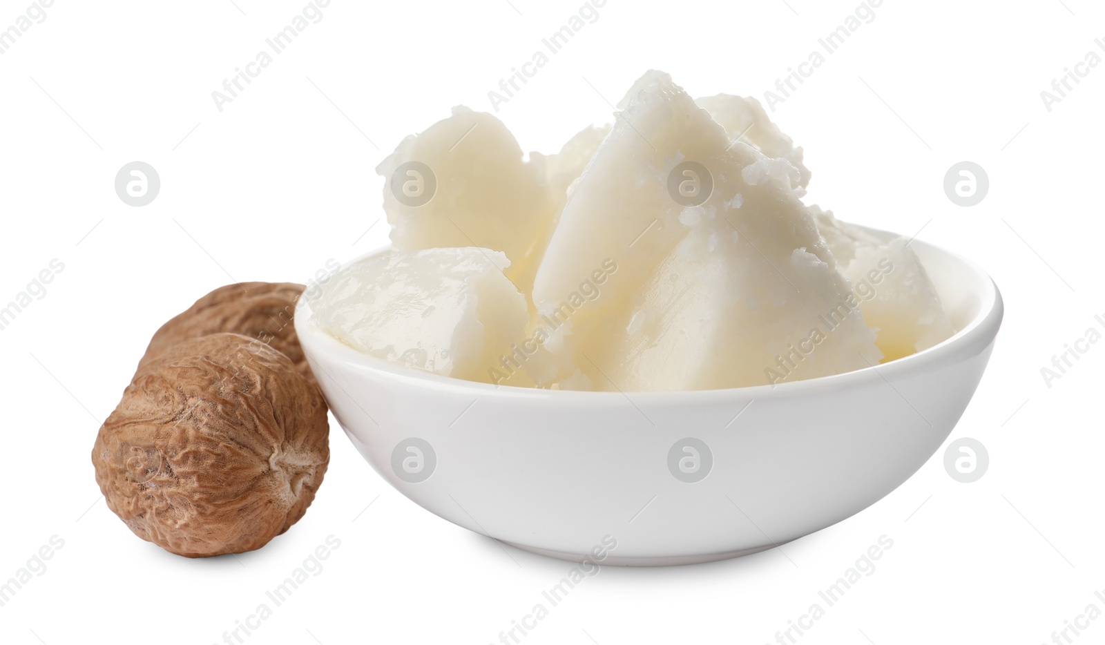 Photo of Natural shea butter in bowl and nuts isolated on white