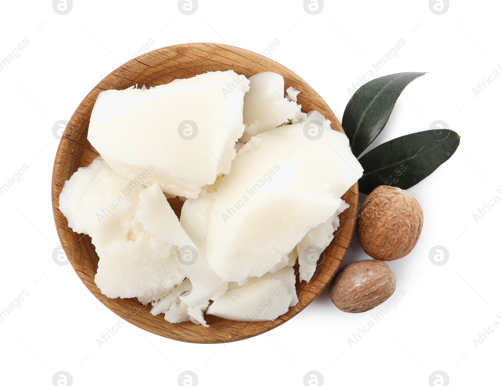 Photo of Natural shea butter, nuts and green leaves isolated on white, top view