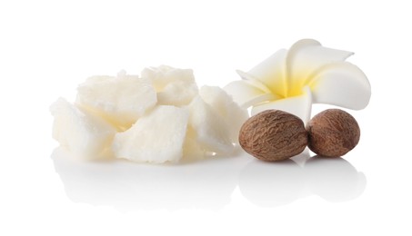 Photo of Natural shea butter, nuts and plumeria flower isolated on white