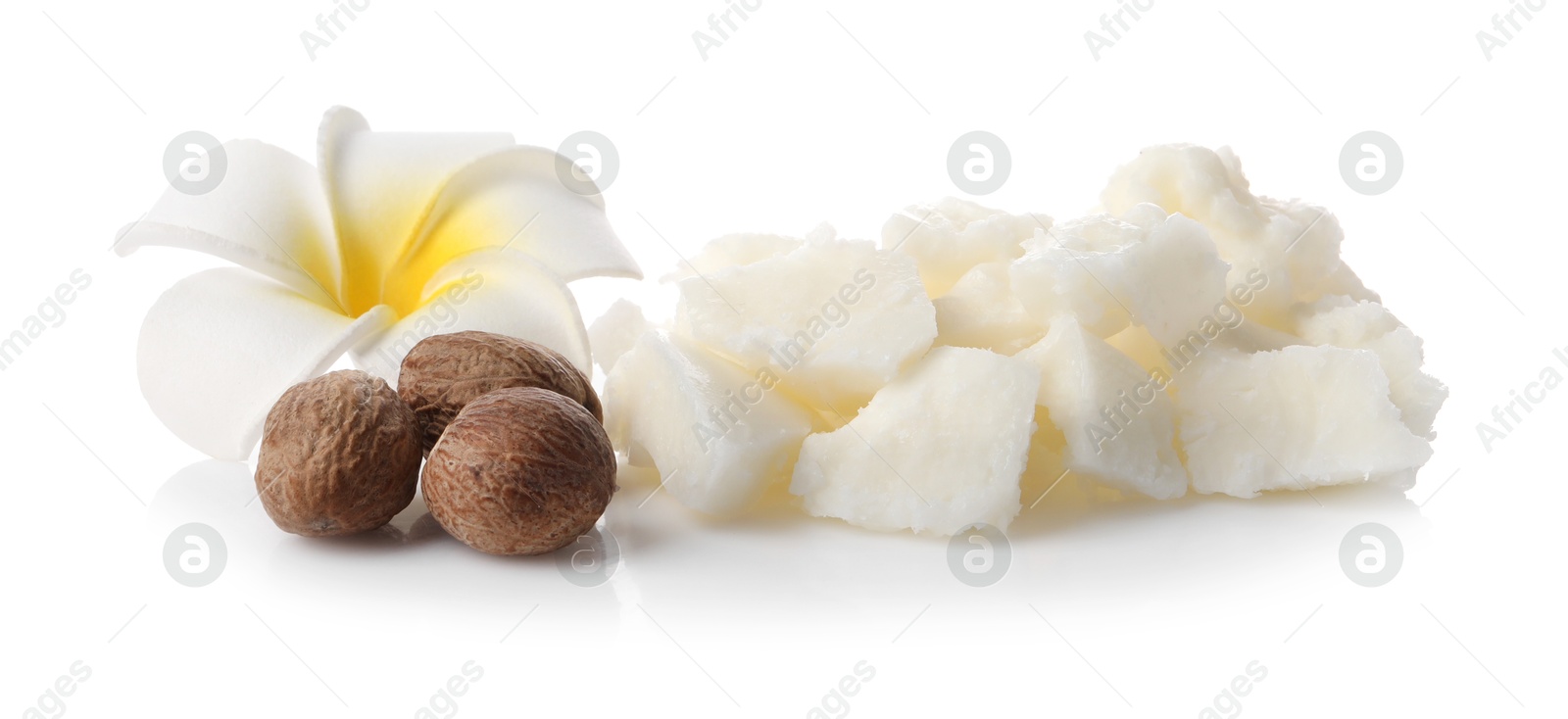 Photo of Natural shea butter, nuts and plumeria flower isolated on white