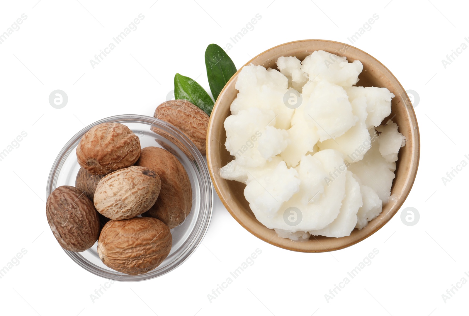 Photo of Shea butter in bowl and nuts isolated on white, top view