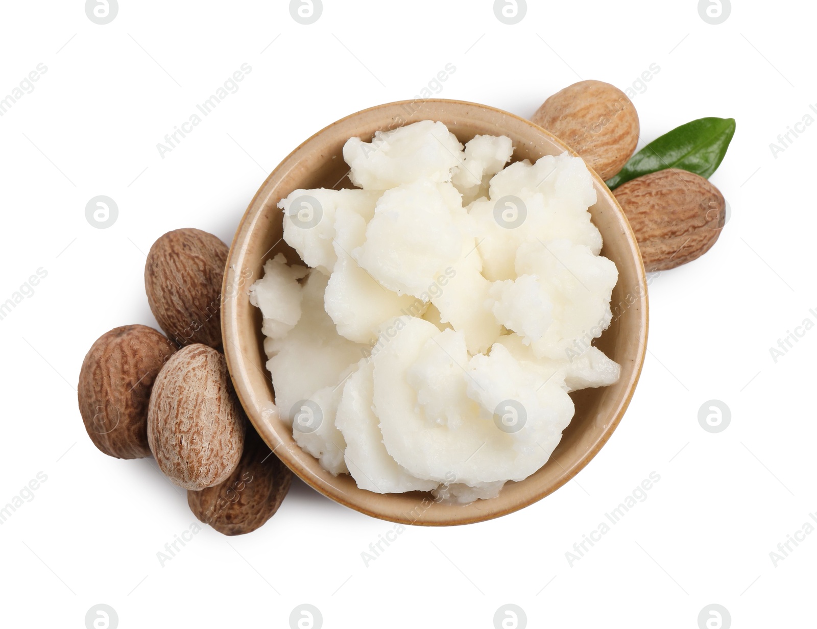 Photo of Shea butter in bowl and nuts isolated on white, top view