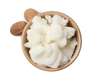 Photo of Shea butter in bowl and nuts isolated on white, top view