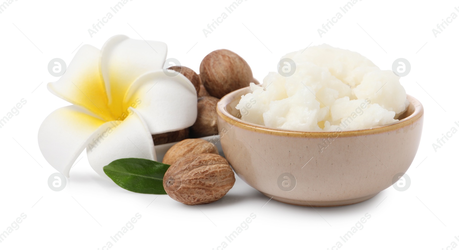 Photo of Shea butter in bowl, flower and nuts isolated on white