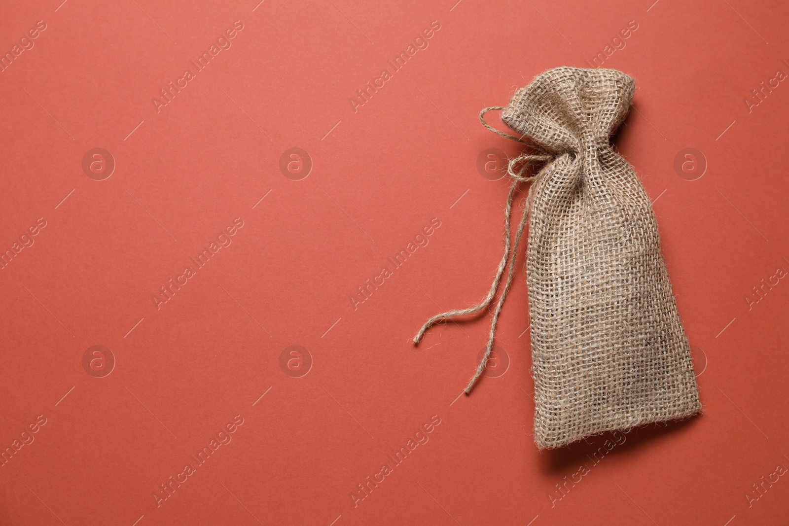 Photo of One burlap sack on color background, top view. Space for text