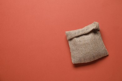 One burlap sack on color background, top view. Space for text