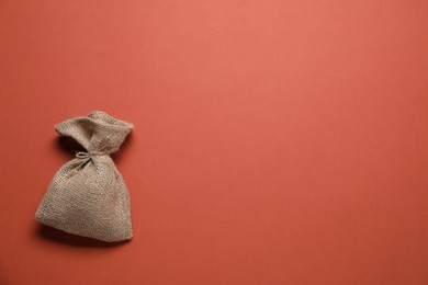 One burlap sack on color background, top view. Space for text