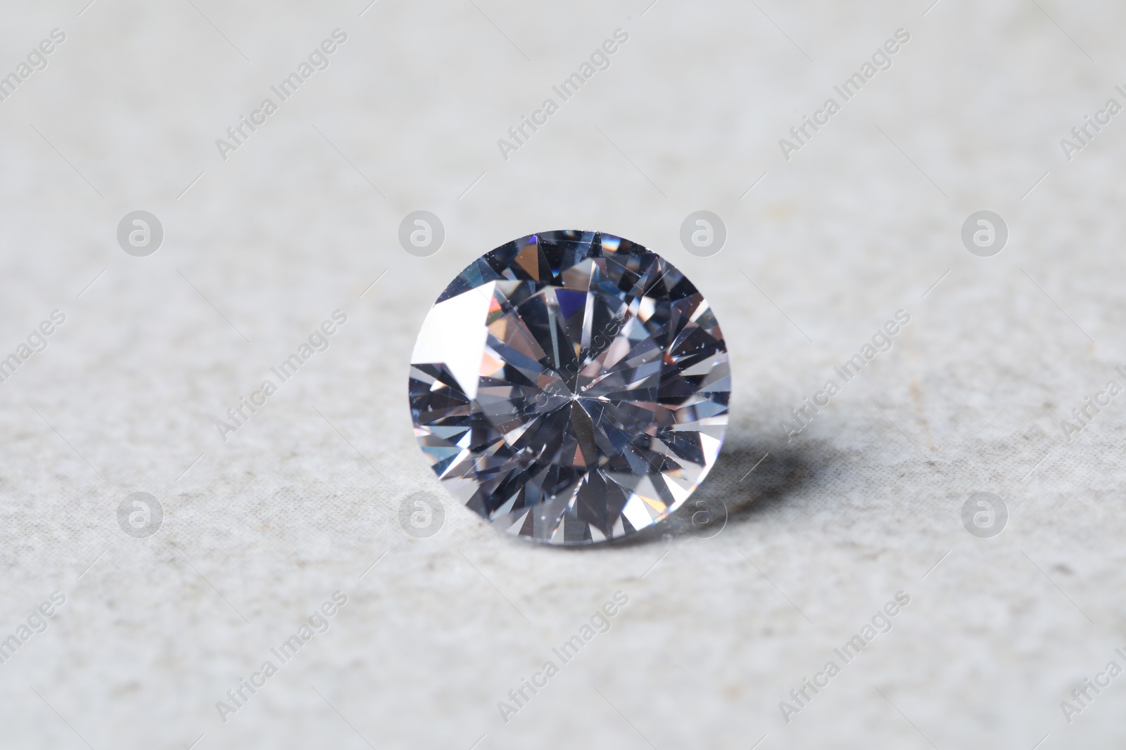 Photo of One beautiful shiny diamond on light background, closeup