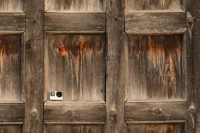 One modern action camera on wooden surface