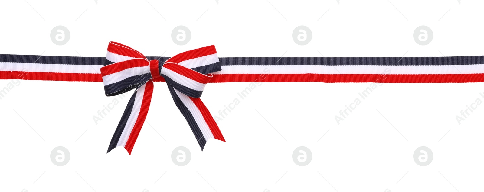 Photo of Ribbon with bow in colors of Yemeni flag isolated on white, top view