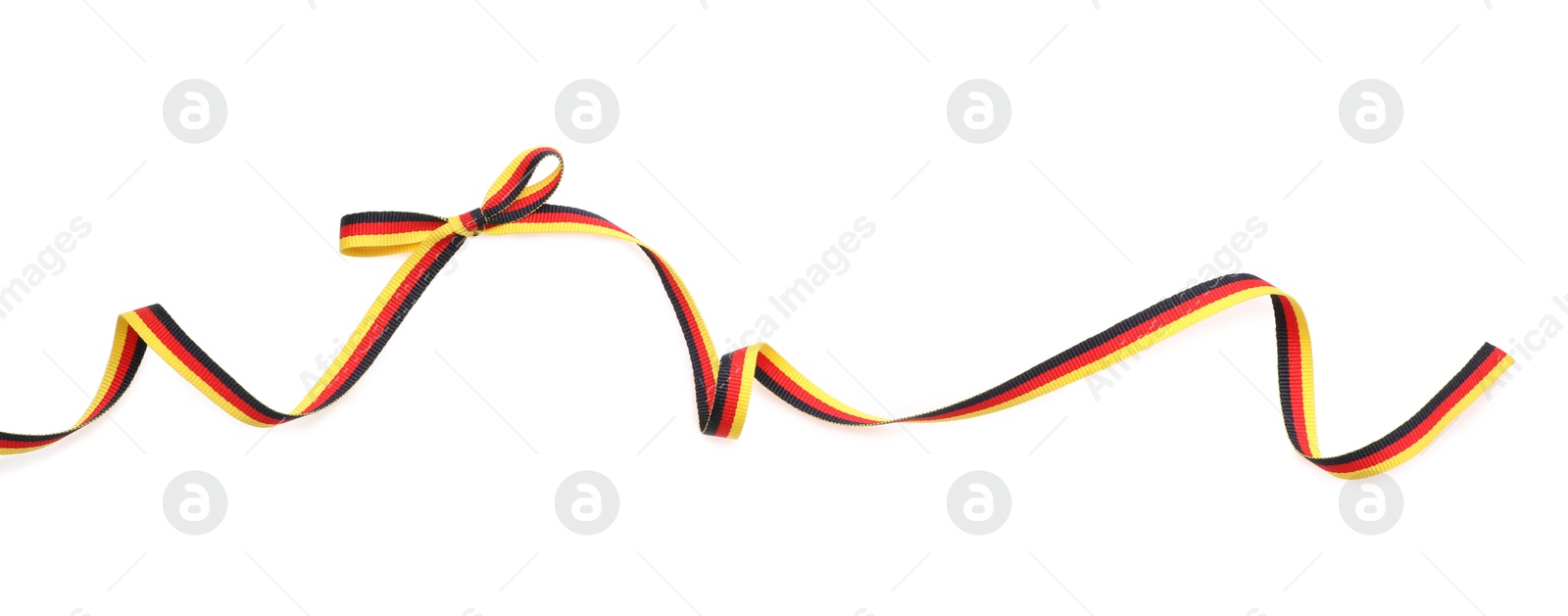 Photo of Ribbon with bow in colors of German flag isolated on white, top view